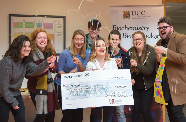 Eabha Wall, Fourth year biochemistry student celebrating with her friends after receiving a cheque for €2000.00 presented to her by the UCC Biochemistry & Biotechnology Society.