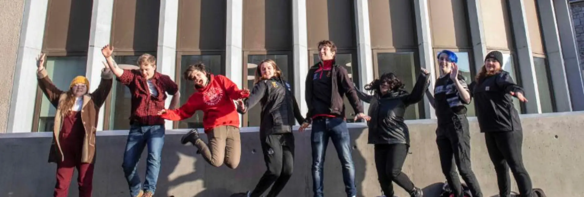 A group of students jumping in celebration