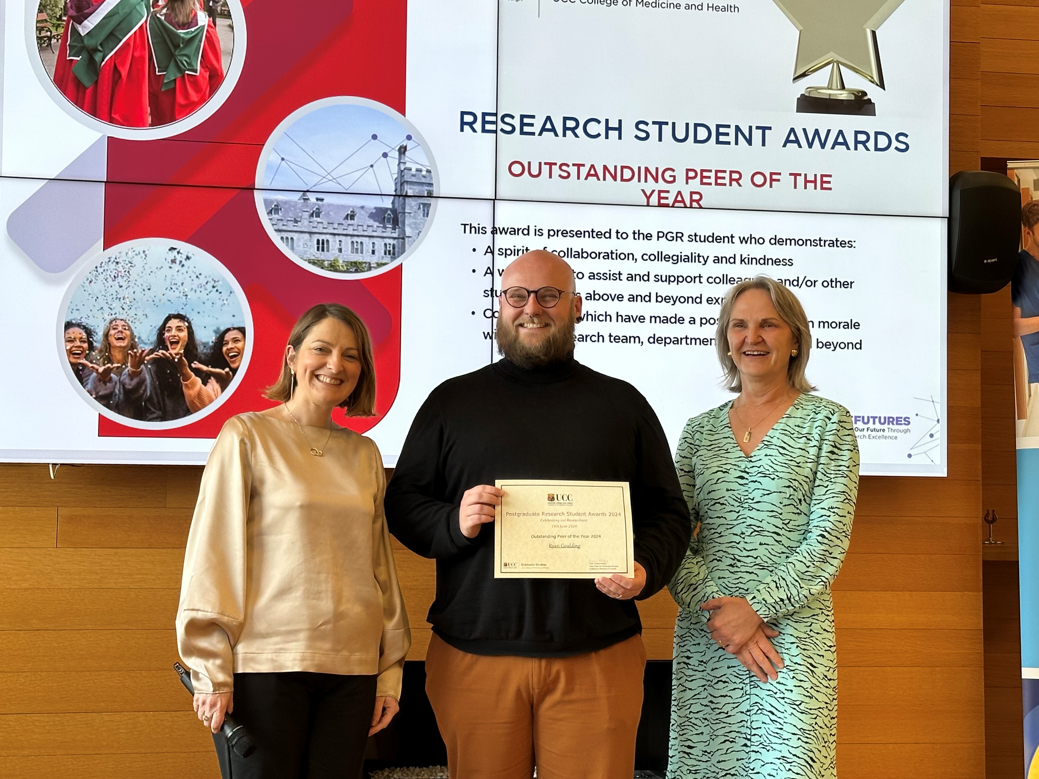 Mx Ryan Goulding, recipient of award for Outstanding Peer of the Year, pictured with Professor Yvonne Nolan, Vice Head of Graduate Studies, CoMH and Professor Helen Whelton, Head of CoMH.