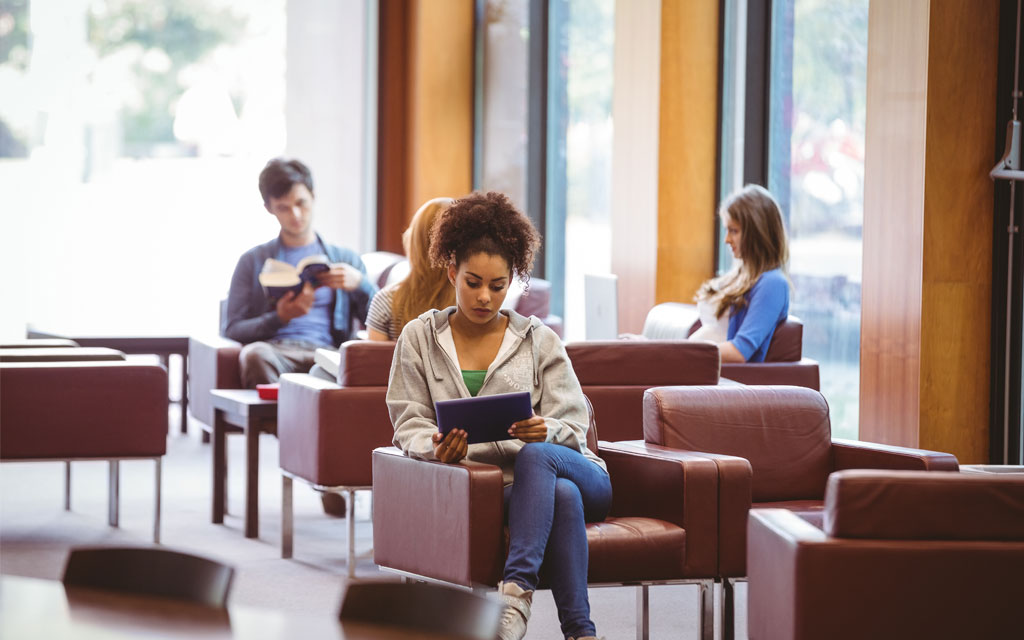 Female student reading on tablet