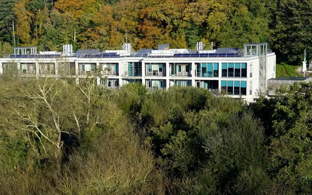The ERI building, pictured nestled amongst the trees on the banks of the River Lee