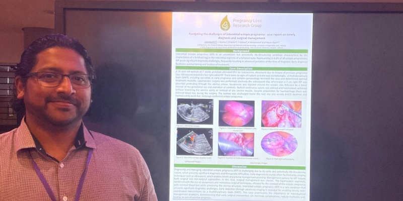 Man standing beside an electronic poster Man standing beside an electronic poster