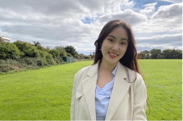 MA Teaching Chinese to Speakers of Other Languages female student, in a cream coat and light blue top, smiling for the camera against the backdrop of a green field. MA Teaching Chinese to Speakers of Other Languages female student, in a cream coat and light blue top, smiling for the camera against the backdrop of a green field.
