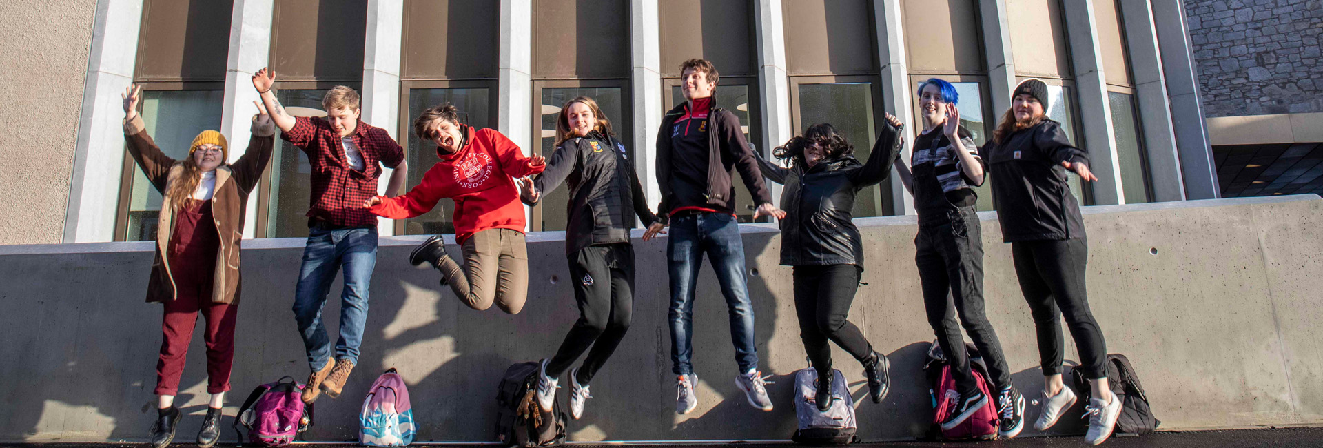 a row of college students jumping