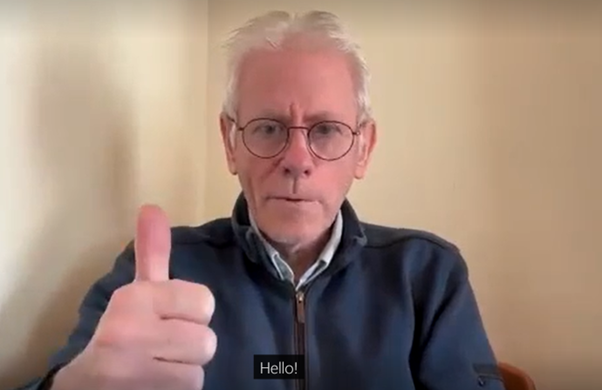A man giving a thumbs up sign with the word 'Hello' in closed captions A man giving a thumbs up sign with the word 'Hello' in closed captions