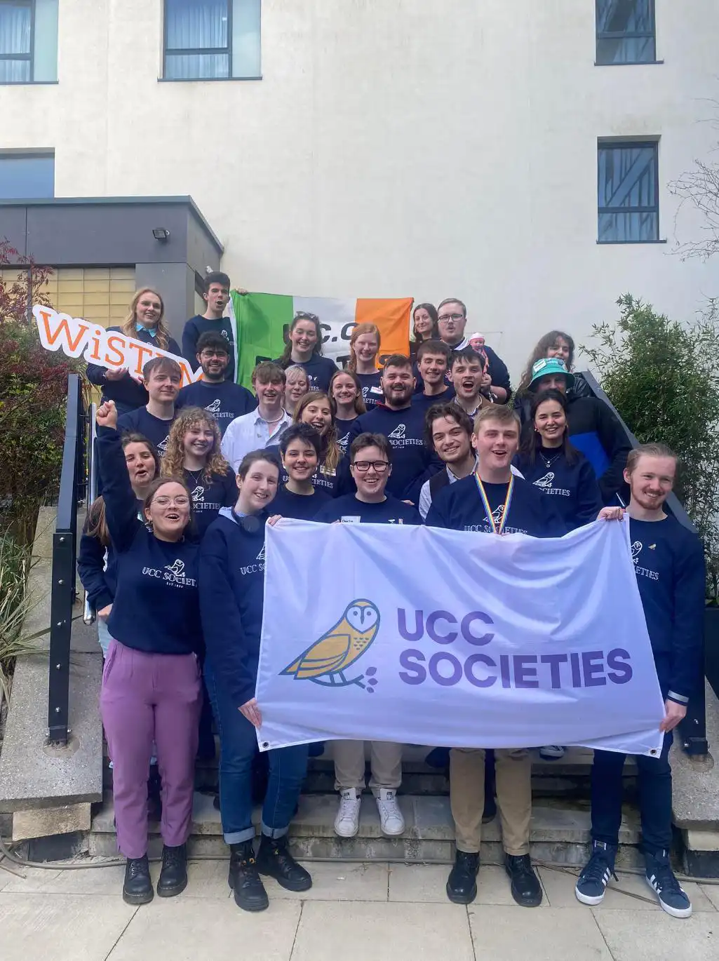 UCC society members hold the UCC Societies flag at BICS 2023 event